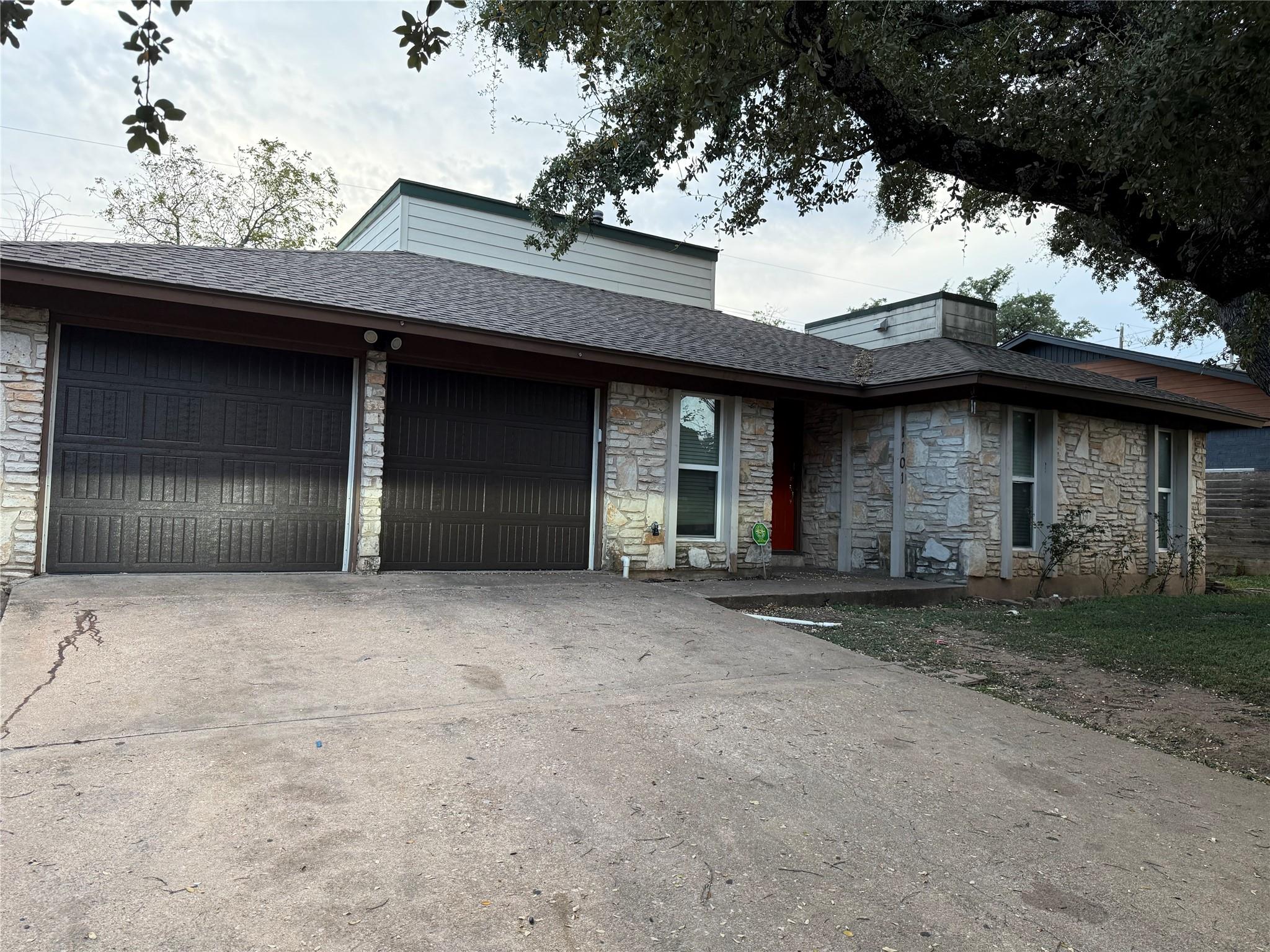 A classic stone facade and shingle roof define th