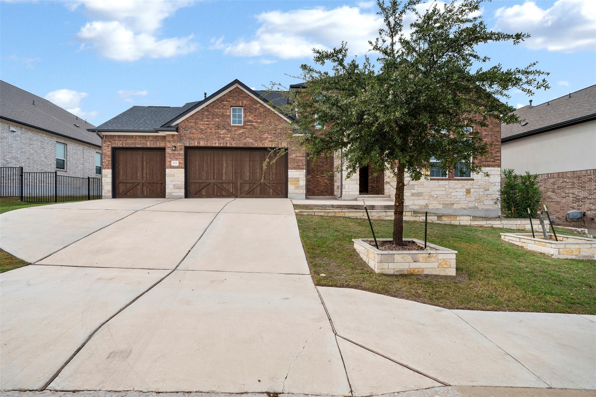 An expansive concrete driveway leads to a classic