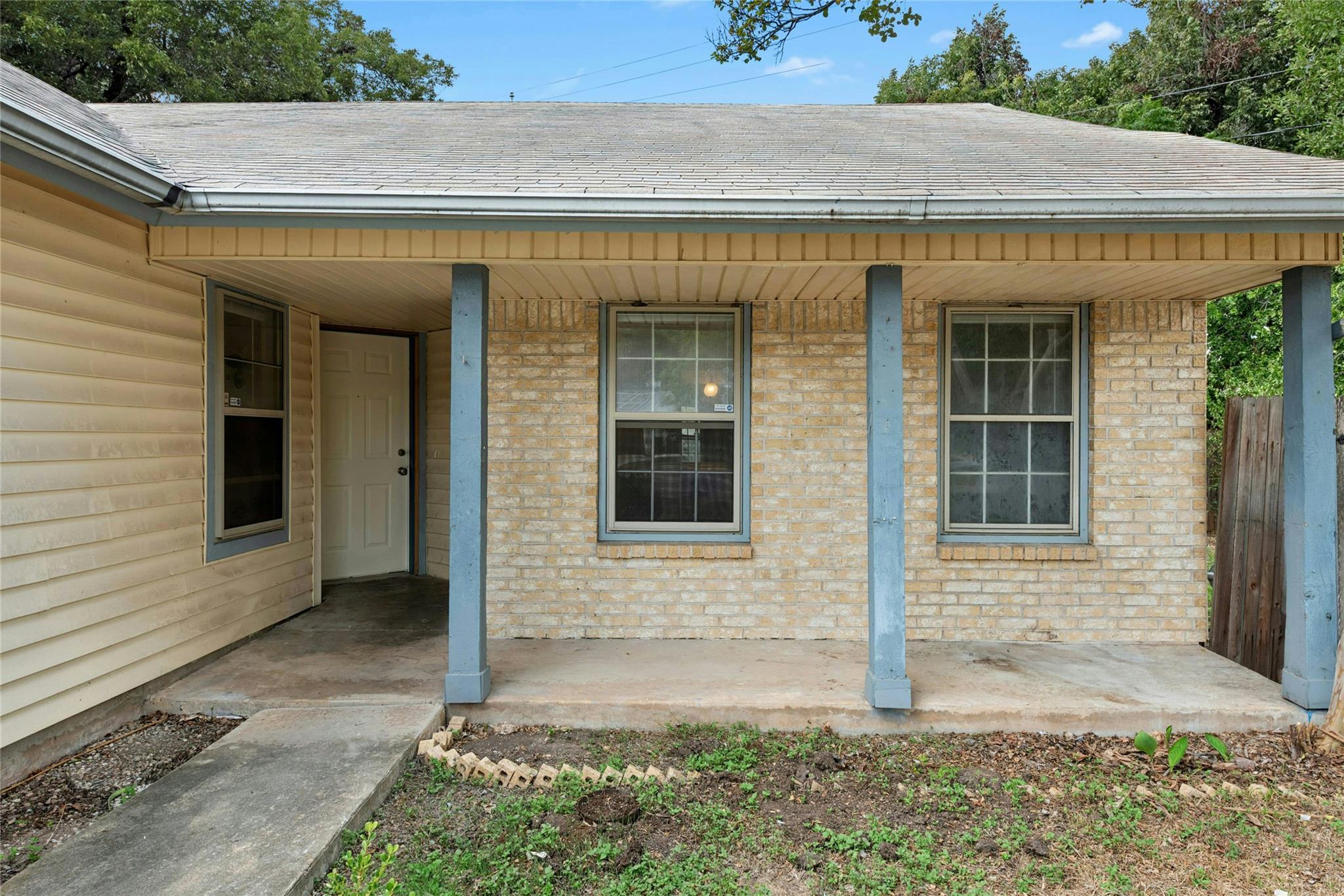 A welcoming front porch with concrete flooring le