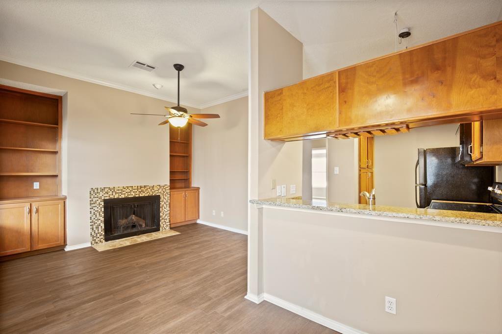 Rich wood built-ins and a tiled fireplace elevate