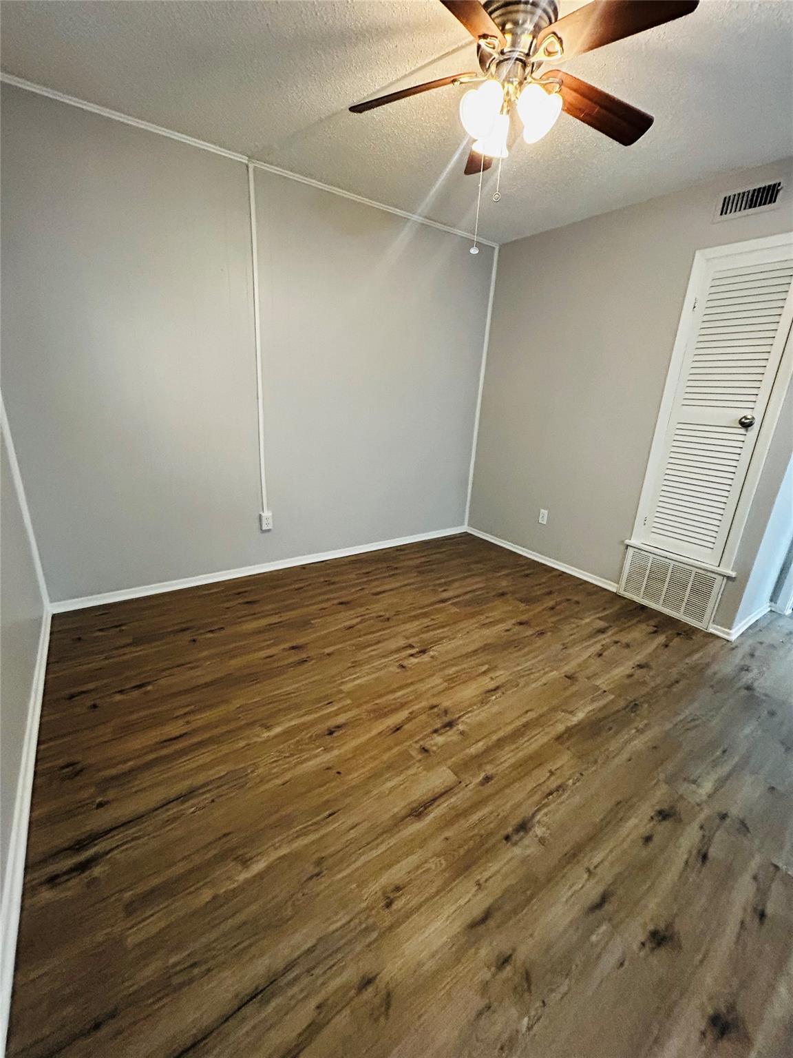 Rich wood-look flooring and clean moldings define