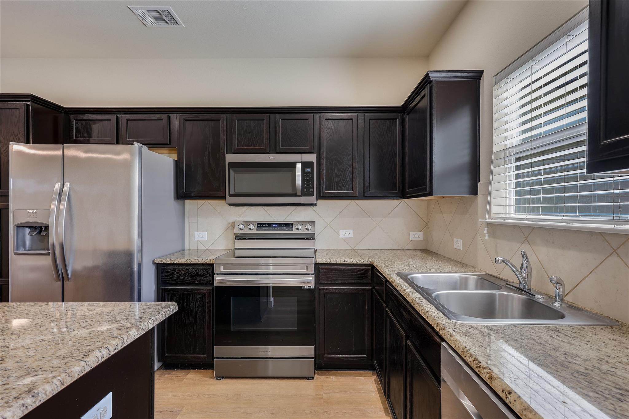 Rich dark cabinetry pairs beautifully with stone 