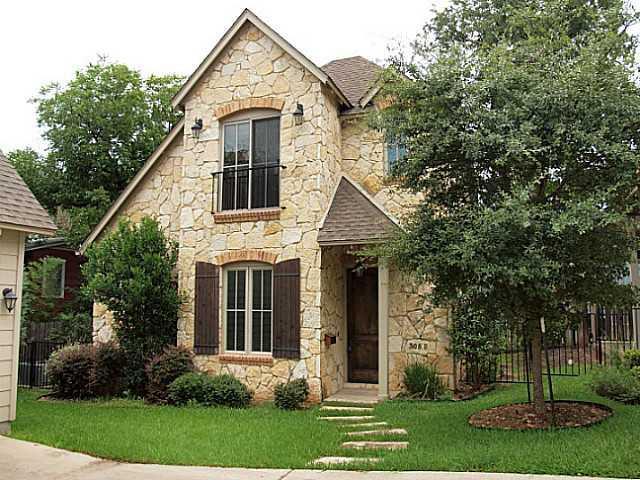 Natural stone masonry and wooden shutters define 