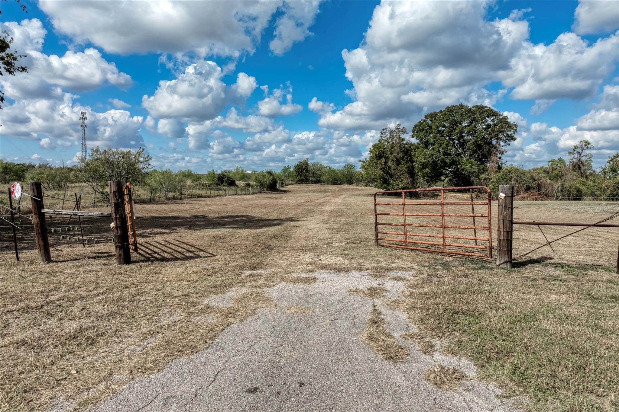 Gated entryways open to a vast pastoral acreage u