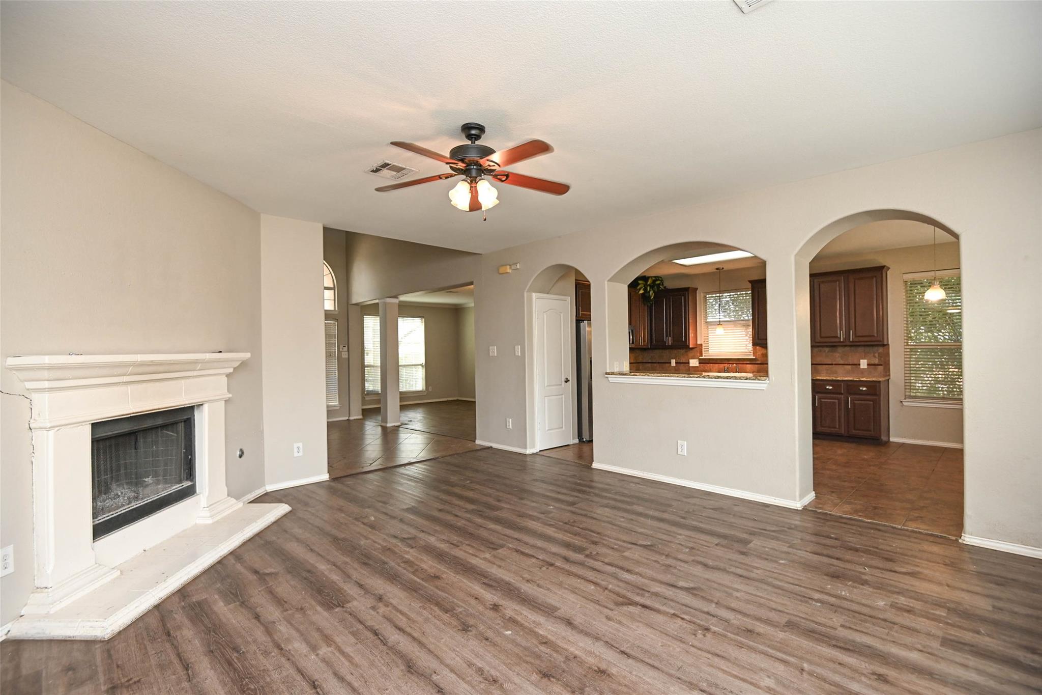 Arched openings frame the adjacent kitchen from t