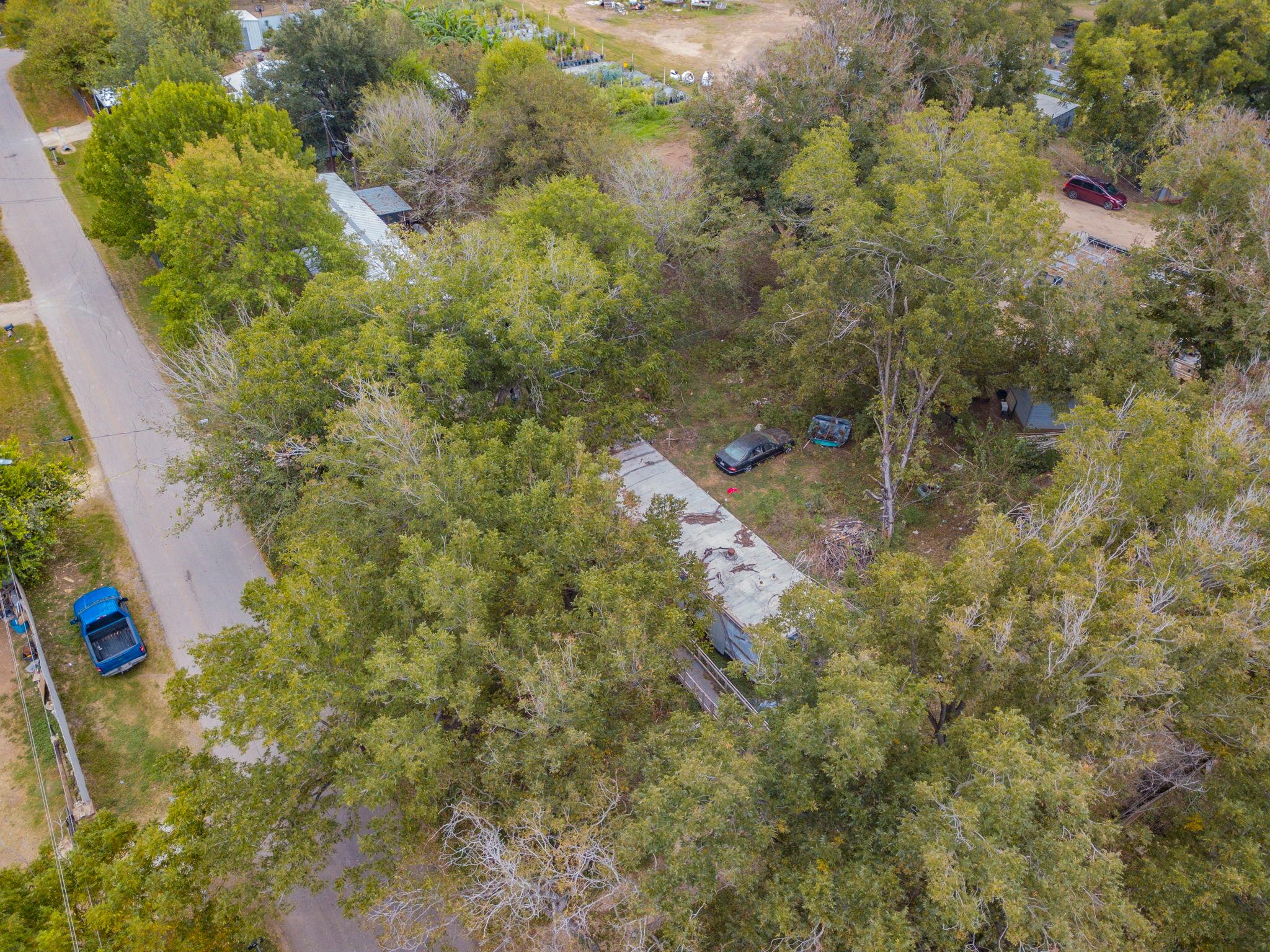 Mature trees surround this property, offering a s