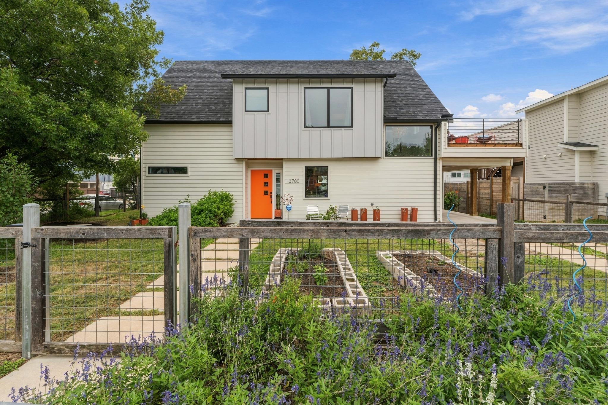 Modern two-story architecture stands framed by a 
