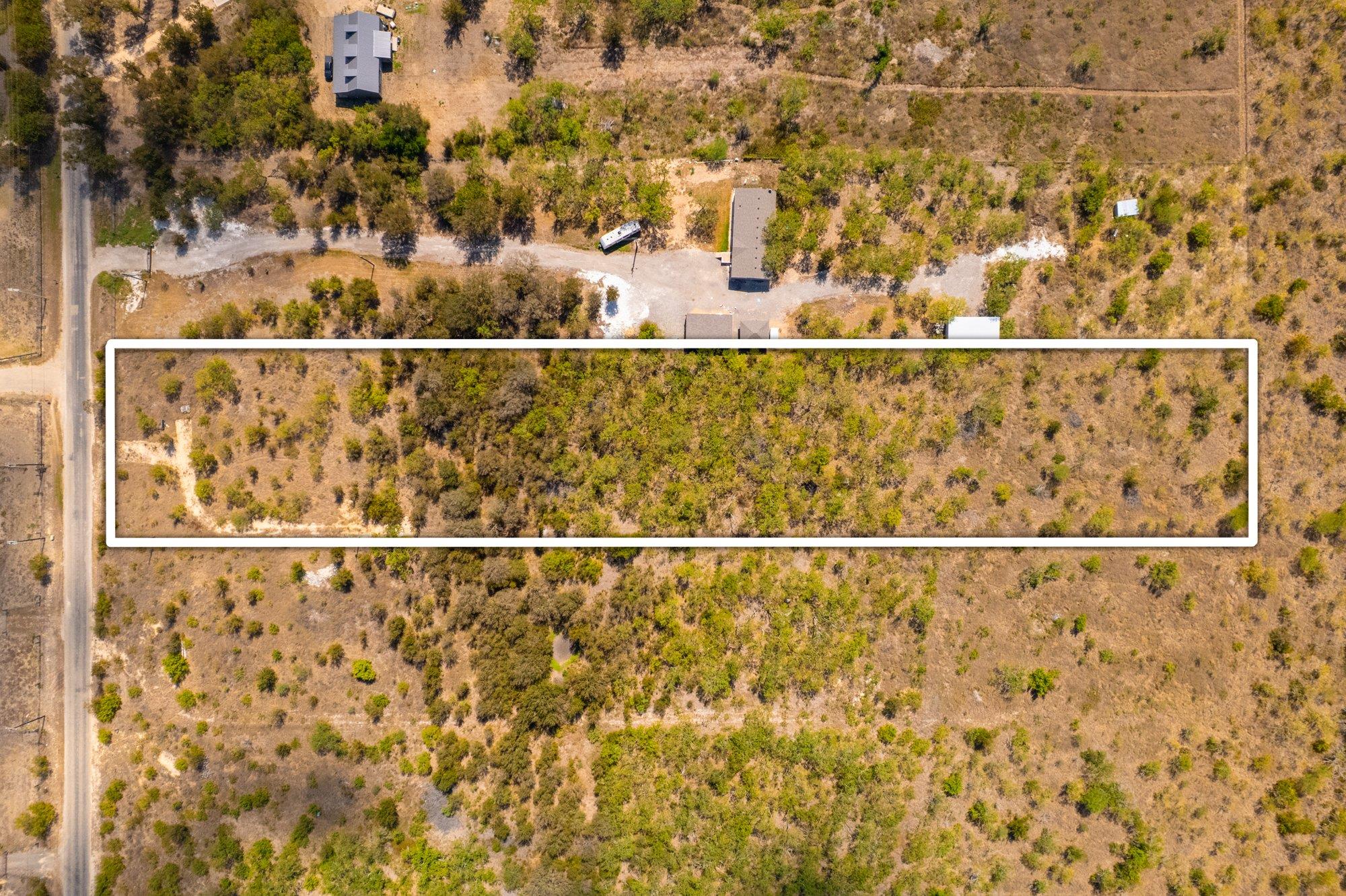 Mature trees and native vegetation cover this lon