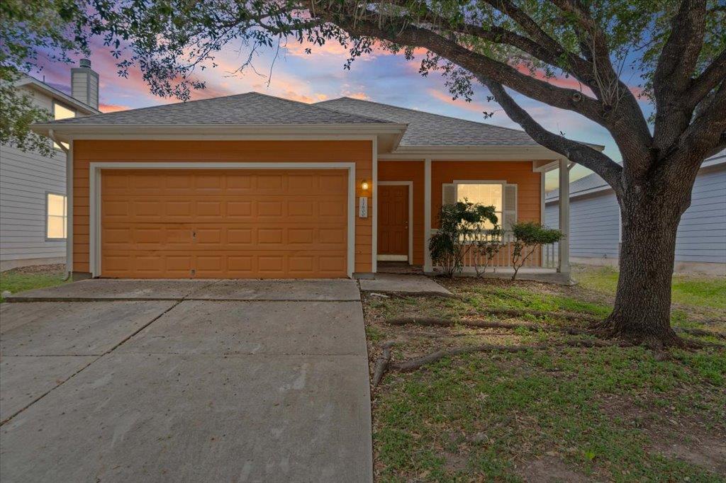 Shaded by a mature tree, this single-story home p