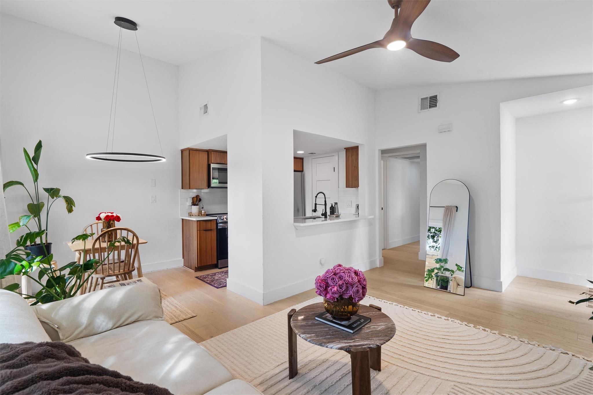Bright, airy living space boasts high ceilings an