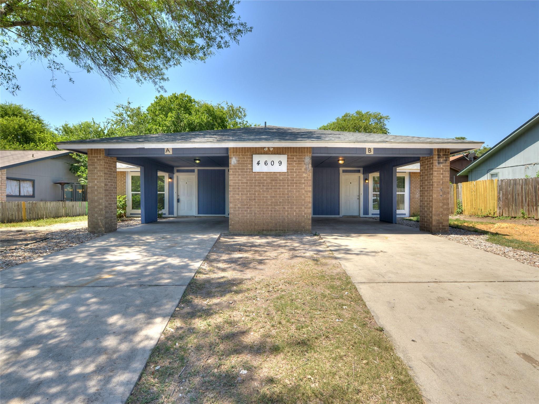 Symmetrical brick and siding duplex facade featur
