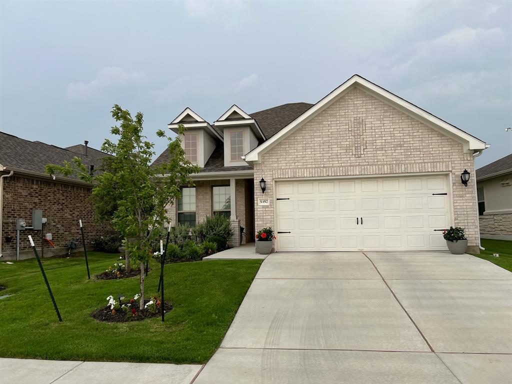 A classic brick exterior and neat landscaping def